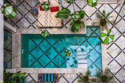 an overhead view of a swimming pool with plants at Riad SofYan & Spa in Marrakech