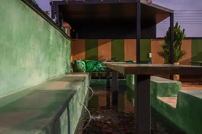 a building with a pond in front of a building at Riad SofYan & Spa in Marrakech