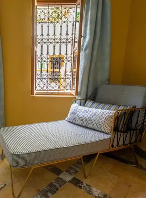 a bench sitting in front of a window at Riad SofYan & Spa in Marrakech