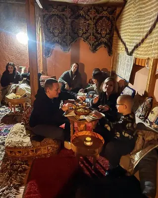 a group of people sitting at a table in a room at Riad La Rose Des Sables in Marrakech