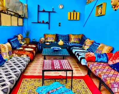 a living room with colorful couches and a table at Hostel Kech Vibe in Marrakech