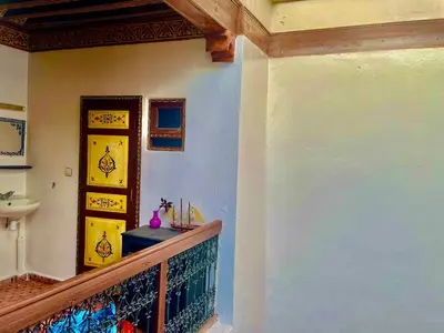 a hallway of a house with a staircase and a sink at Hostel Kech Vibe in Marrakech