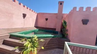 a hot tub on the roof of a house at Riad Lalla Mimouna in Marrakech