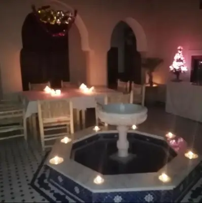 a living room with a table and a bowl in the middle at Dar Aouinti in Marrakech