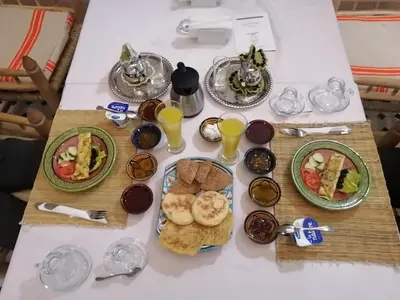 a table topped with plates of food and drinks at Dar Aouinti in Marrakech