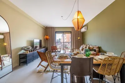 a dining room and living room with a table and chairs at L'Atelier N°12, Loft, Terrasse in Marrakech