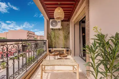 a balcony with a table and chairs and a speaker at L'Atelier N°12, Loft, Terrasse in Marrakech
