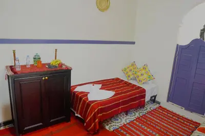 a bedroom with a bed with a cat on the bedspread at Winarouze house in Marrakech