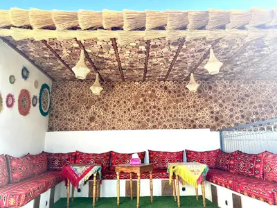 a room with red couches and tables on a wall at Winarouze house in Marrakech