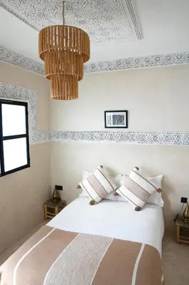 a bedroom with a bed and a chandelier at Riad21 in Marrakech