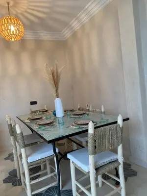 a dining room with a table and chairs at Riad21 in Marrakech