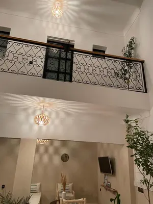 a staircase in a living room with tables and chairs at Riad21 in Marrakech