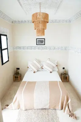 a bedroom with a bed and a chandelier at Riad21 in Marrakech