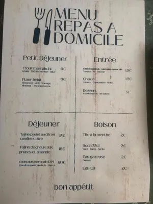 a menu for a restaurant with a fork and knife at Appartement cosy et discret in Marrakech