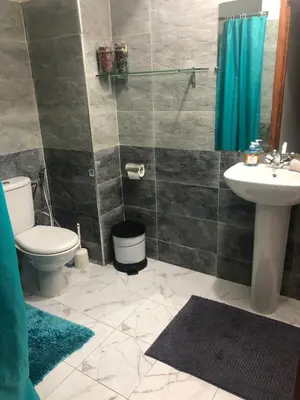 a bathroom with a toilet and a sink at Appartement cosy et discret in Marrakech