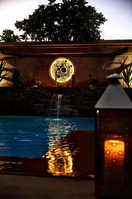 a fountain in front of a pool of water at Villa Taj Sofia & Spa in Marrakech