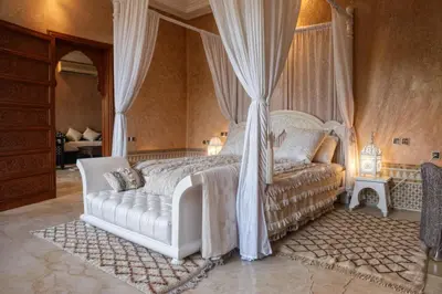 a bedroom with a white bed with a canopy at Villa Taj Sofia & Spa in Marrakech