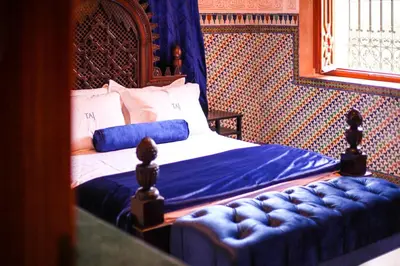 a bedroom with a bed and a couch in it at Villa Taj Sofia & Spa in Marrakech