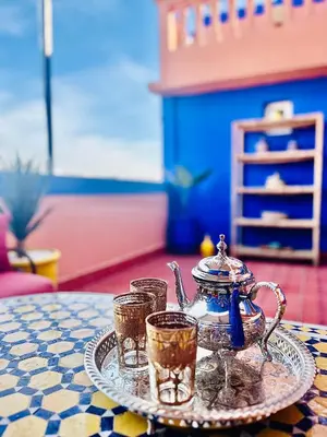a tray with a tea pot and two glasses on a table at Terrasse Majorelle & Mogador in Marrakech