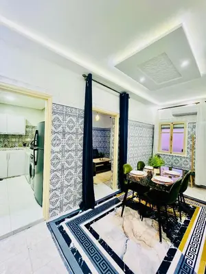 a living room with a table and a kitchen at Terrasse Majorelle & Mogador in Marrakech
