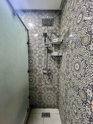 a bathroom with a shower with a mosaic wall at Mamounia Patio & Rooftop in Marrakech