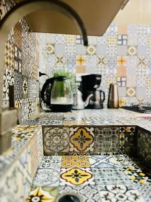 a kitchen with a counter with tiles on it at Mamounia Patio & Rooftop in Marrakech