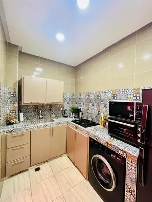 a kitchen with a washer and dryer in it at Mamounia Patio & Rooftop in Marrakech