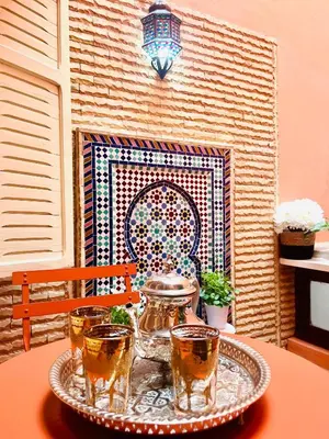 a tray of drinks on a table in front of a fireplace at Mamounia Patio & Rooftop in Marrakech