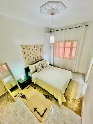 a bedroom with a bed and a window at Mamounia Patio & Rooftop in Marrakech