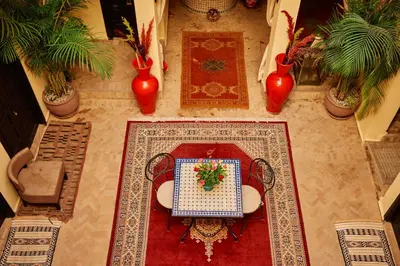 an overhead view of a table and chairs on a rug at Riad Dar La Rose in Marrakech