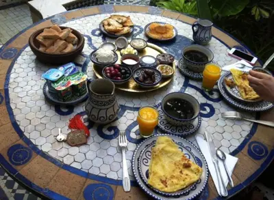 a table topped with breakfast foods and orange juice at RIAD TENDANCE IN MARRAKECH in Marrakech