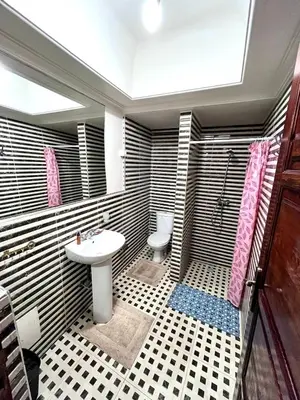 a bathroom with a sink and a toilet at RIAD TENDANCE IN MARRAKECH in Marrakech
