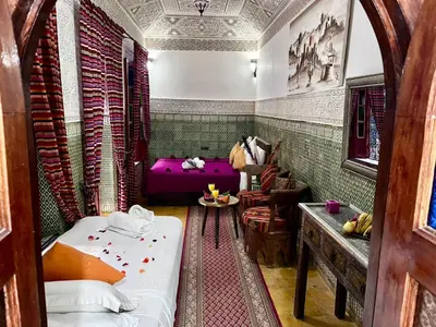 a room with two beds and a couch in it at RIAD TENDANCE IN MARRAKECH in Marrakech