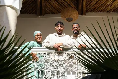 a group of three people standing behind a railing at Riad Amour in Marrakech
