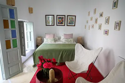 a bedroom with a bed with a table and chairs at Riad Amour in Marrakech