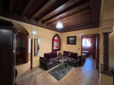 a living room with a couch and a table at Superbe appartement avec parking gratuit in Marrakech
