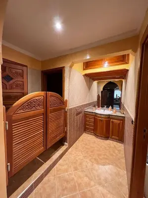 a large kitchen with a sink and a counter at Superbe appartement avec parking gratuit in Marrakech