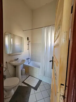 a bathroom with a tub and a sink and a toilet at Duplex el Madina in Marrakech