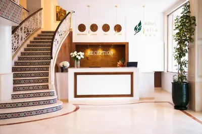 a lobby with a large white screen in the middle of a staircase at Hotel Safia in Marrakech