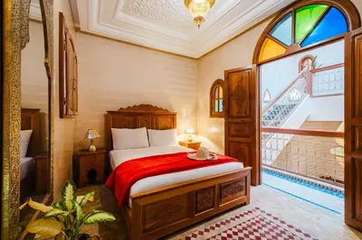 a bedroom with a bed and a large window at Riad Cozy Marrakech, Shared Pool with 3 Rooms in Marrakech