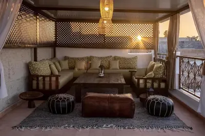 a living room with a couch and a table at Riad Villa Berna under Swiss Management in Marrakech