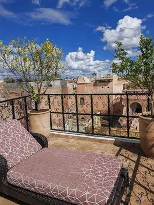 a bed sitting on top of a balcony at Riad Villa Berna under Swiss Management in Marrakech