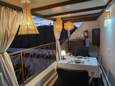 a dining room with a table and a balcony at Riad Villa Berna under Swiss Management in Marrakech