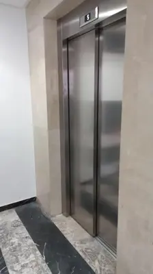 a large metal elevator in a building at Appartement cosy au cœur de Marrakech avec piscine in Marrakech