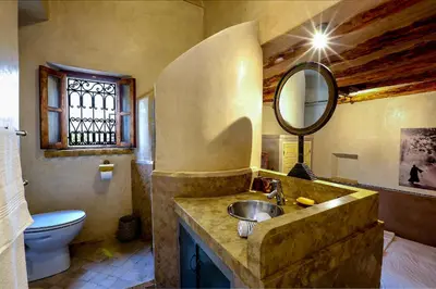 a bathroom with a sink and a toilet and a mirror at Riad 92 - Architect's Riad in the Exclusive Dar El Bacha in Marrakech