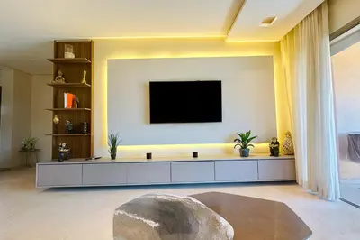 a living room with a tv on a wall at Appartement de luxe prestigia Golf Resort in Marrakech