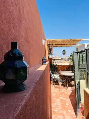 a wall with a light on it next to a patio at Riad MS holidays terrasse privatisé Marrakech in Marrakech