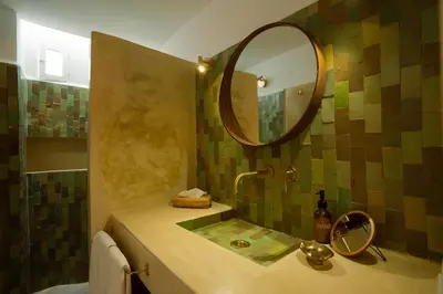 a bathroom with a sink and a mirror at Riad Rahal in Marrakech