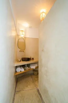 a bathroom with a shelf and a mirror on a wall at Riad Rahal in Marrakech