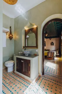a bathroom with a toilet and a mirror at Kenzara Suites & Pool, Your private escape in Marrakech